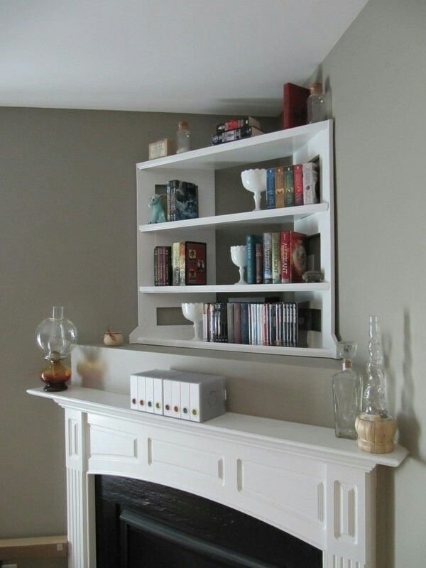 Built-in bookshelves integrated into the wall above a fireplace