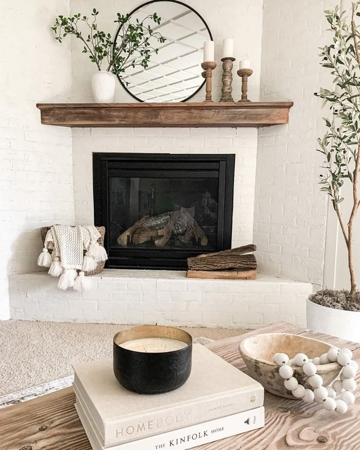 Minimal floating shelf above a fireplace styled with curated decor