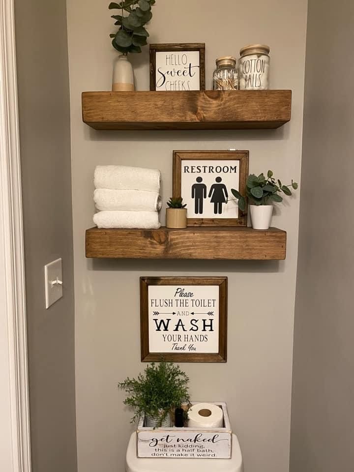 Bathroom styled with personal touches including framed art and mixed decor objects instead of a matching set