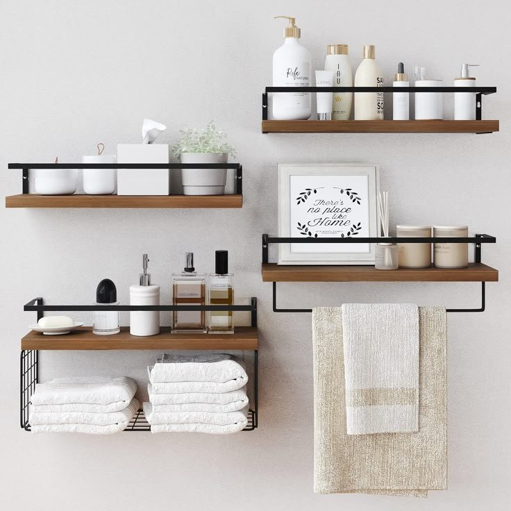 Rustic wood bathroom shelf with neatly rolled towels, apothecary jars and a diffuser, matching the warm tones throughout