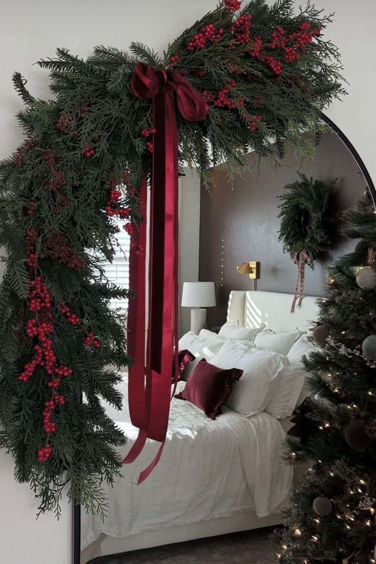 Christmas greenery and wreath decorating a bedroom mirror
