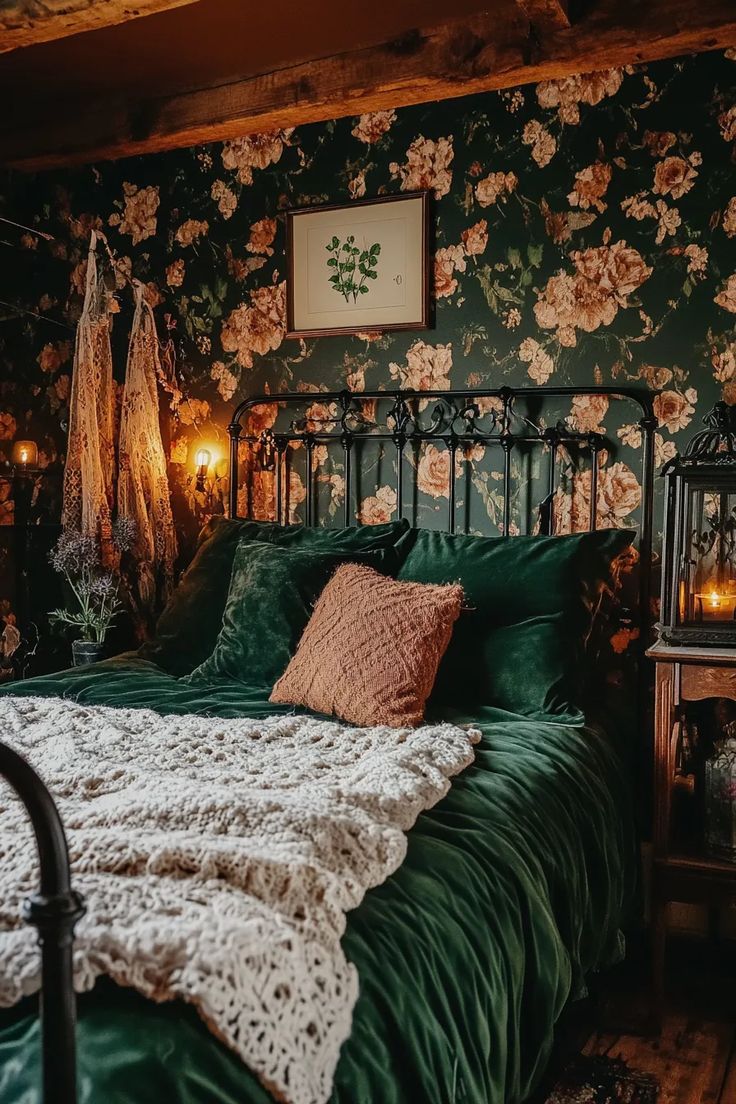 Cottagecore bedroom with dark moody floral wallpaper behind a black iron bed frame