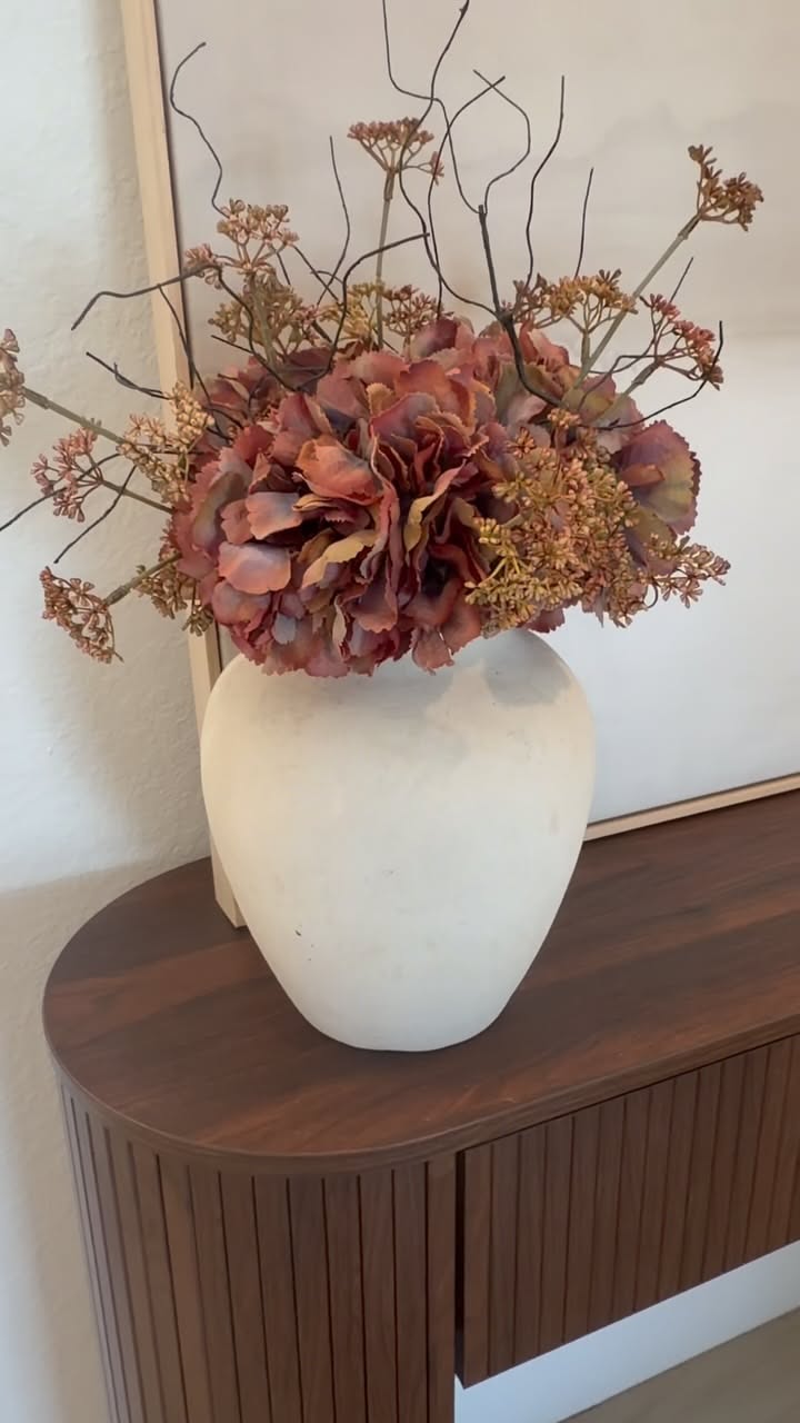 Dried flower bouquet in a white vase on a cottagecore bedroom dresser