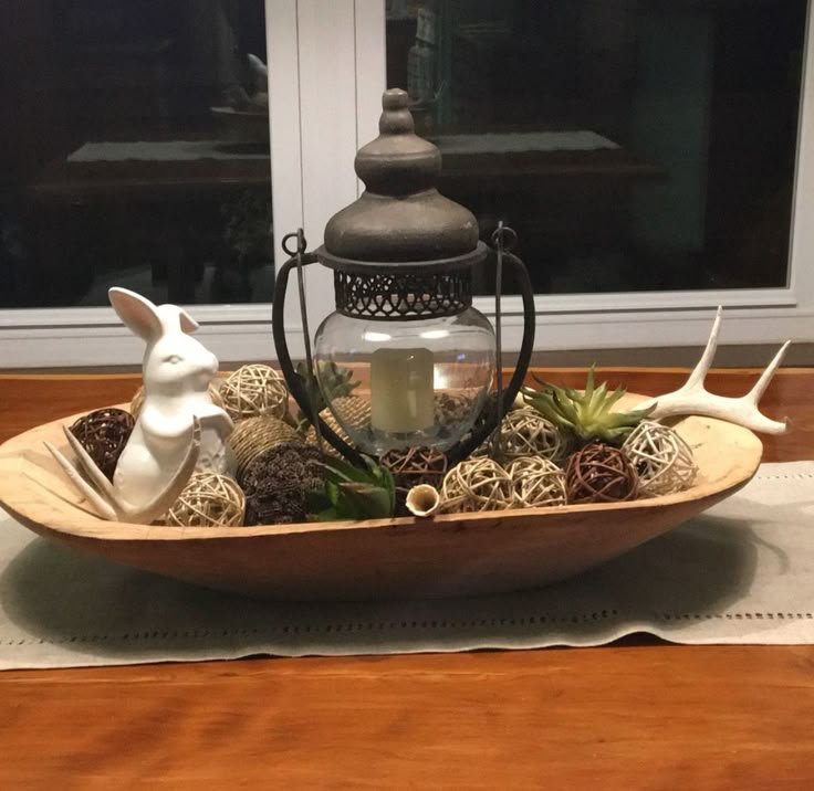 Rustic dough bowl filled with seasonal decor as a centerpiece