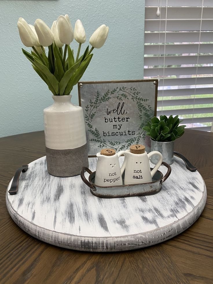 Low floral arrangement in a neutral vase as a dining table centerpiece
