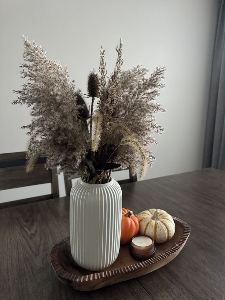 Single statement vase with branches as a minimal dining table centerpiece