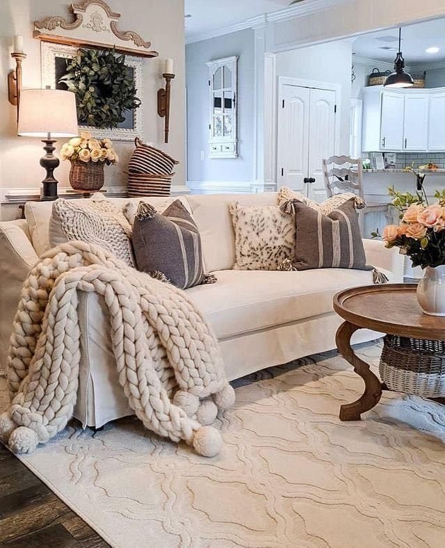 Layered neutral textiles styled in a farmhouse living room