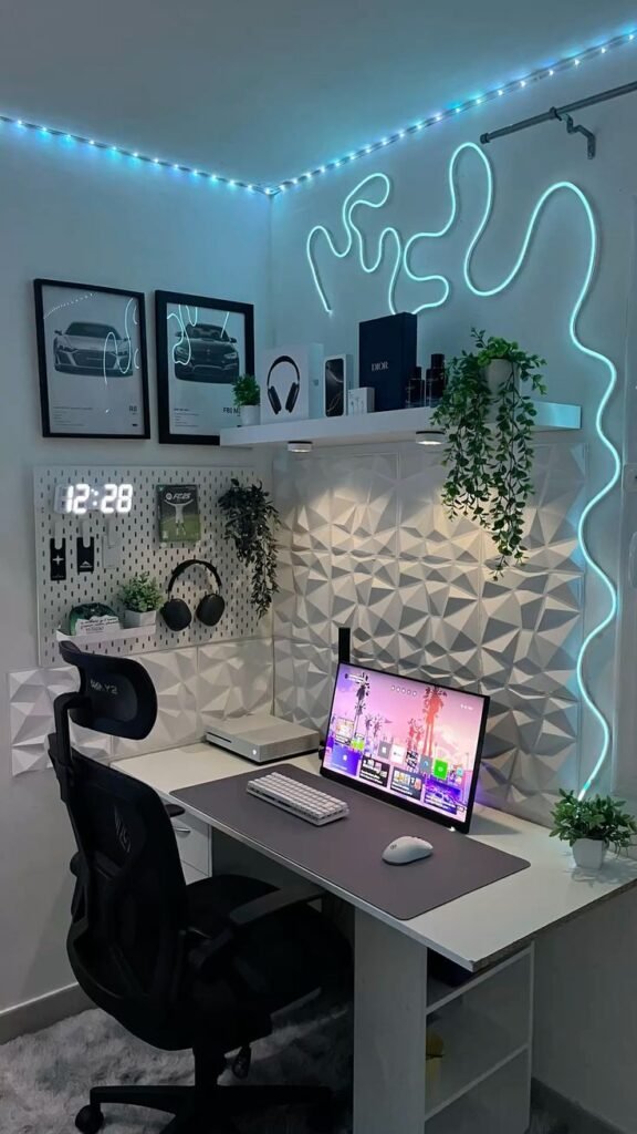 Corner gaming desk setup with a teal neon light strip, pegboard organizer and dual monitor on a white desk