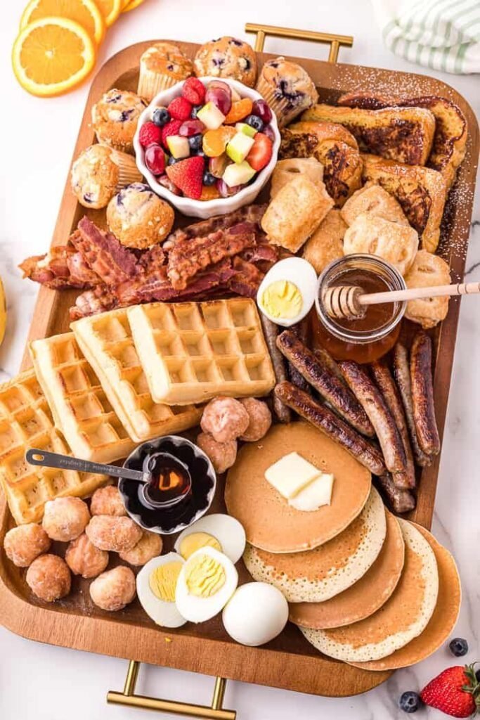 Brunch charcuterie board with pastries and fresh fruit