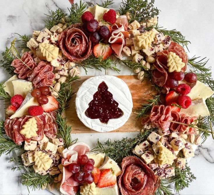 Holiday charcuterie wreath board with cheese, meats and berries