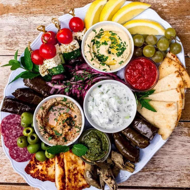Mediterranean-style charcuterie board with hummus and olives