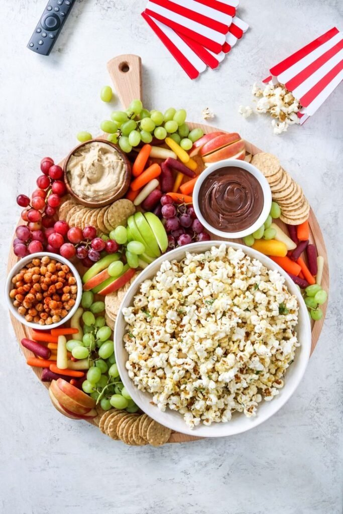 Fun movie night snack board with popcorn and treats