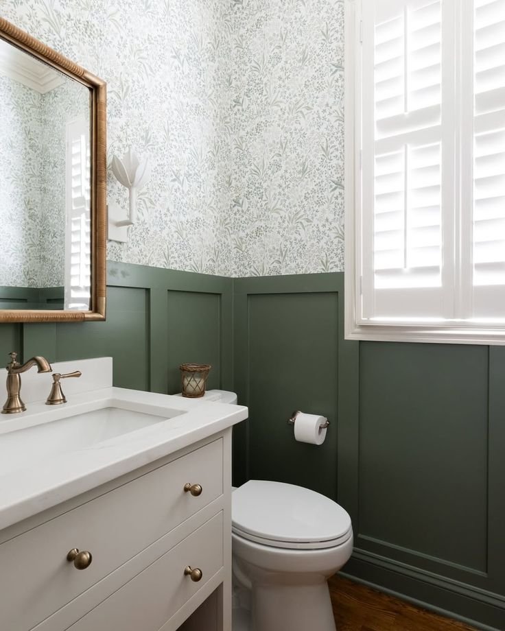 Bold green botanical wallpaper transforming a powder room