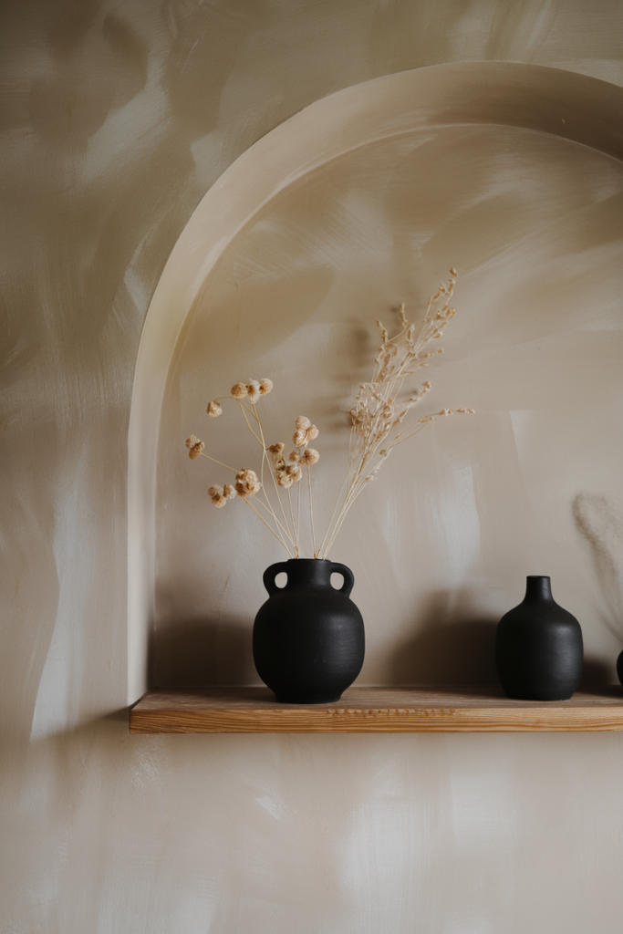 A touch of black grounding the room's light, neutral palette