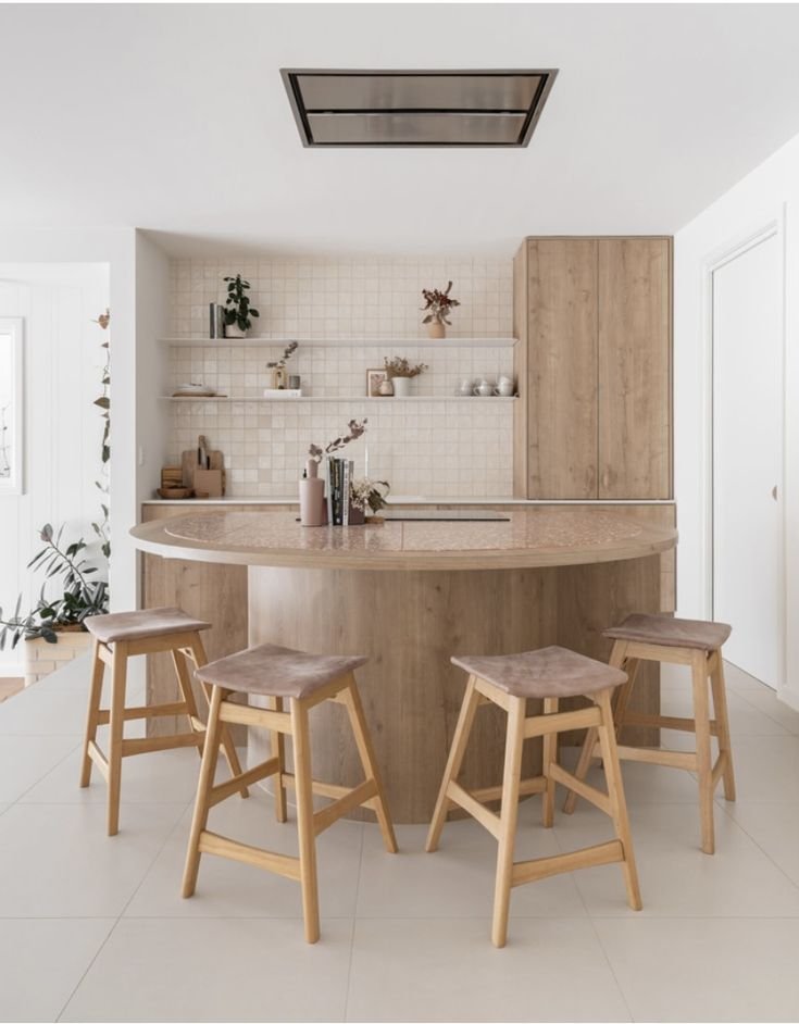 Rounded kitchen island softening the room's hard angles