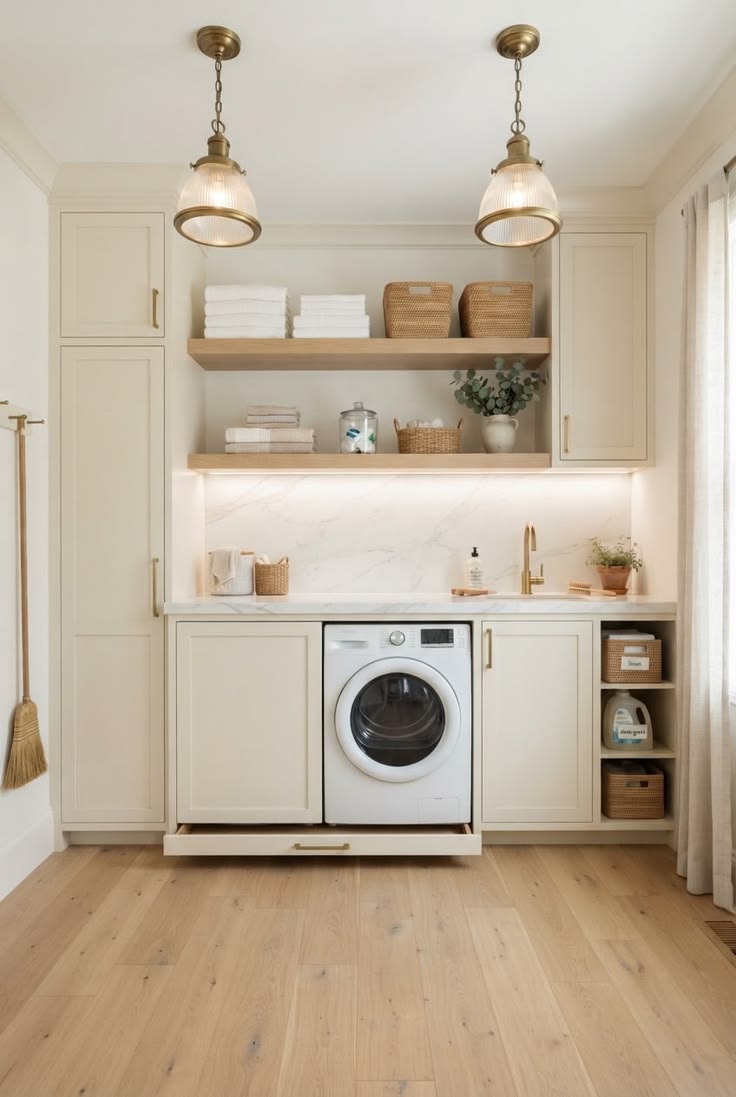 Laundry room styled with brass pendant lights, floating wood shelves and a marble backsplash above a hidden washer