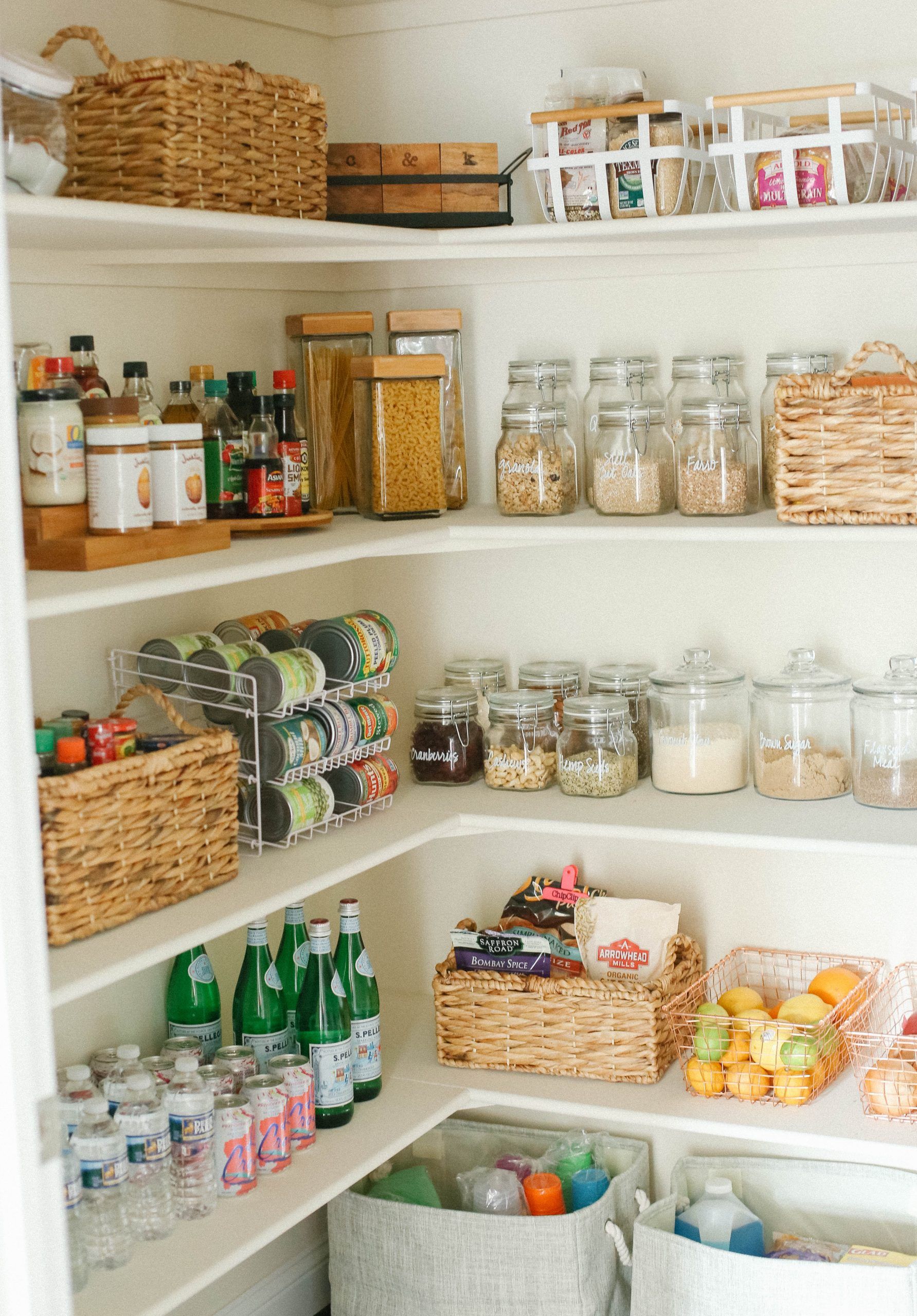 Corner pantry shelves with glass jars hand-labeled Granola, Cranberries, Cashews, Brown Sugar and Flaxseed Meal