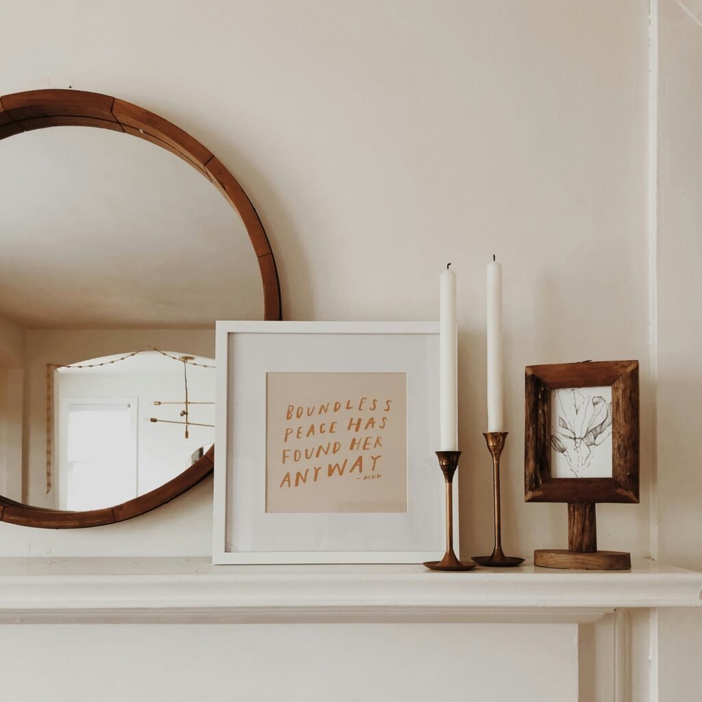 Simple winter mantel display with candles and natural greenery