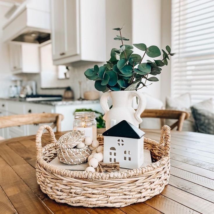 Dramatically layered round tray decor with sculptural objects and books