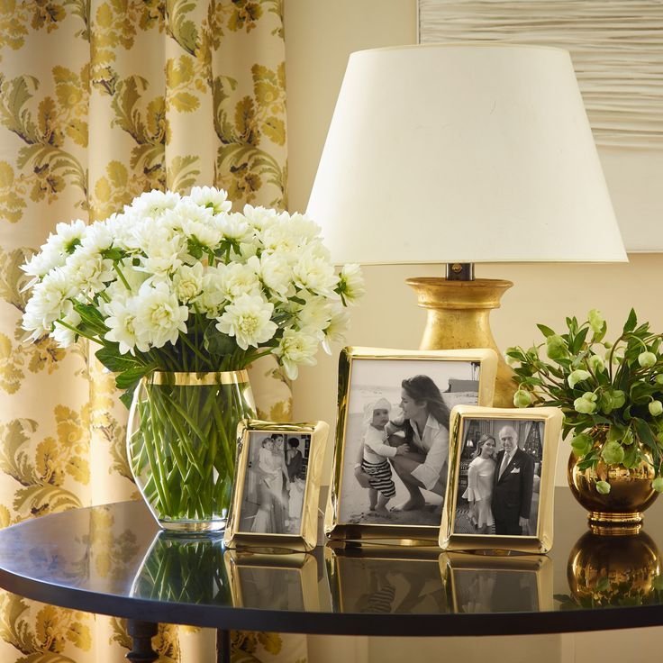 Framed black and white art leaned casually on a side table