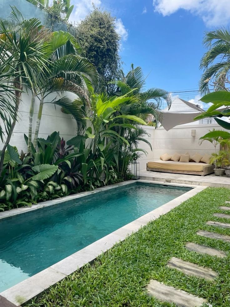 Private courtyard pool surrounded by lush tropical greenery