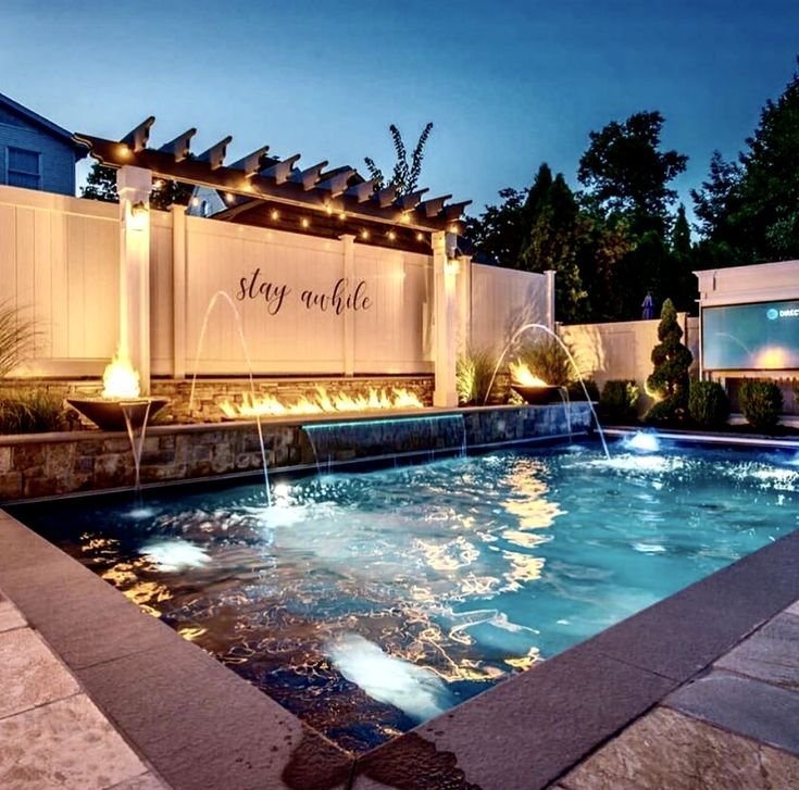 Small pool with a fire feature adding drama at night