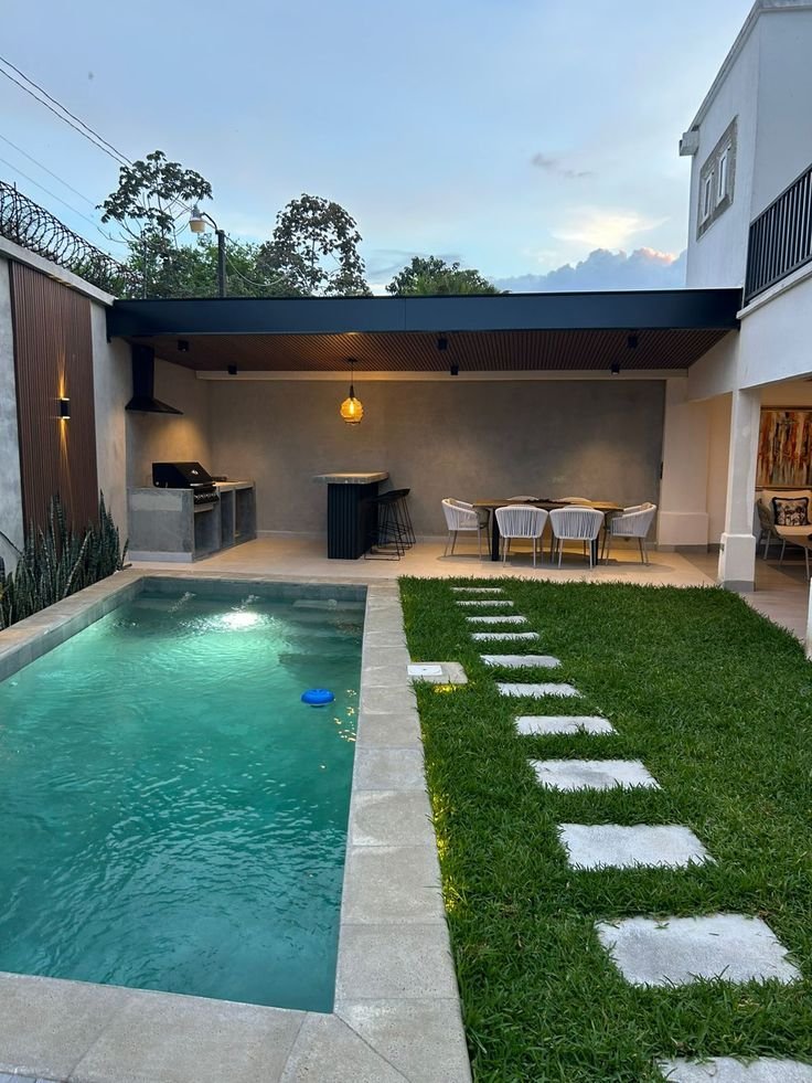 Small backyard pool with a terrace showing how compact pools can still feel luxurious
