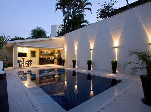 Small pool transformed by layered lighting at night
