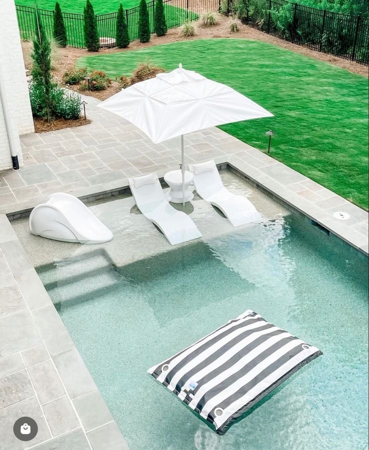 Pool with a built-in sun shelf replacing poolside furniture