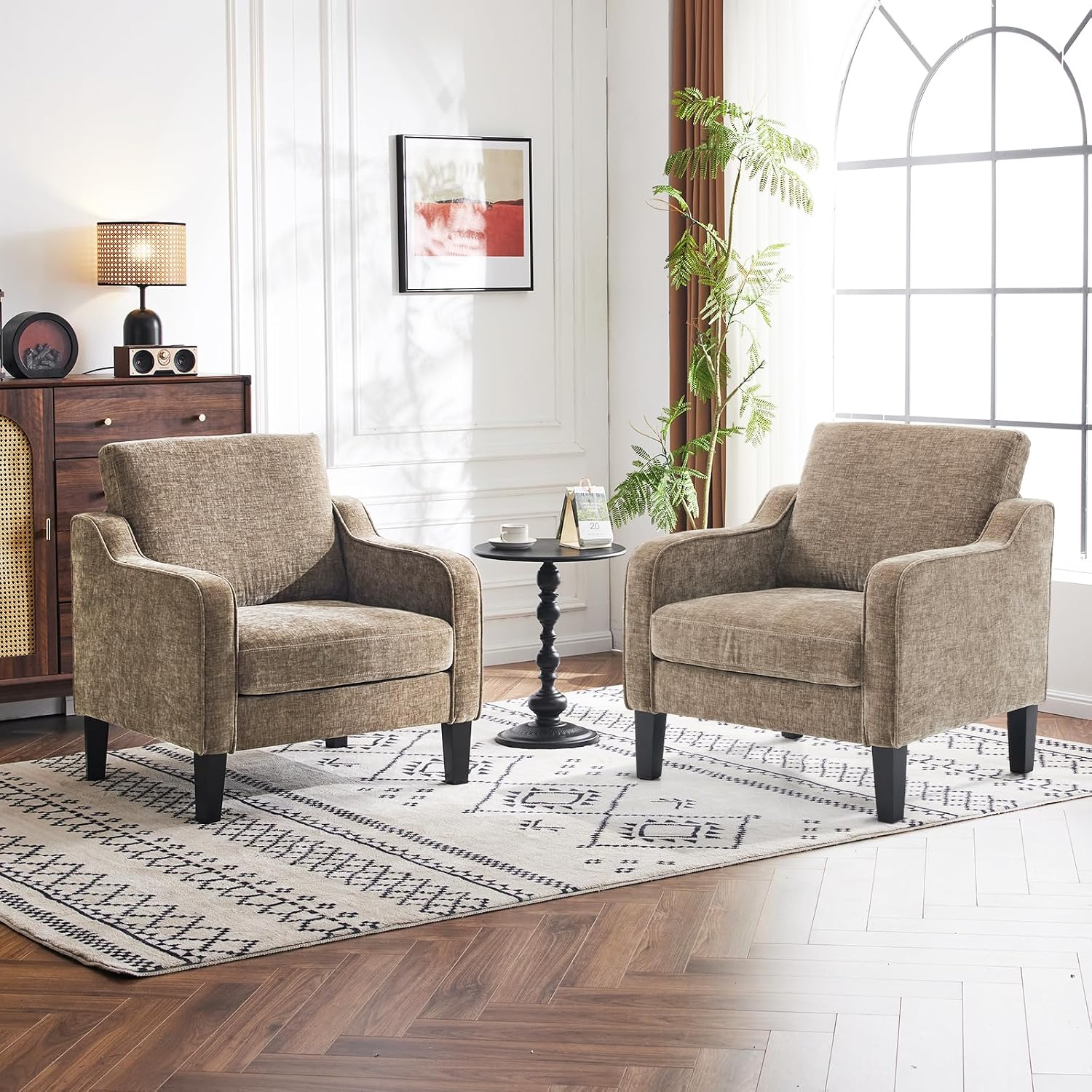 Two matching tan upholstered accent chairs beside a sofa