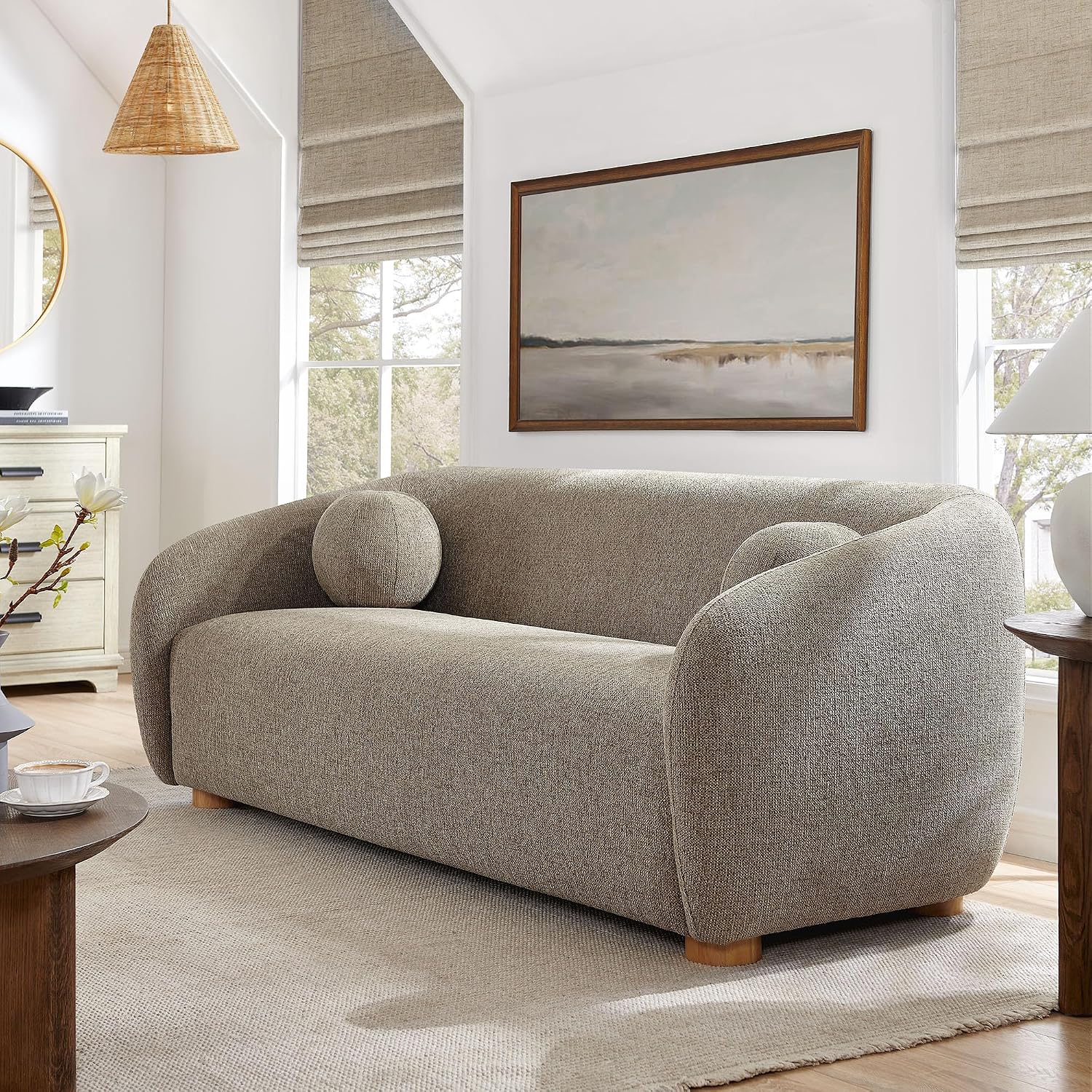 Taupe minimalist sofa with a curved back and rounded wood feet
