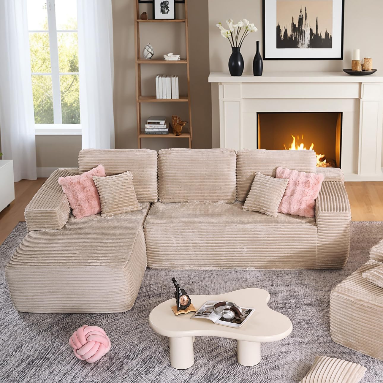 Beige corduroy L-shaped sectional sofa with a deep chaise in front of a fireplace