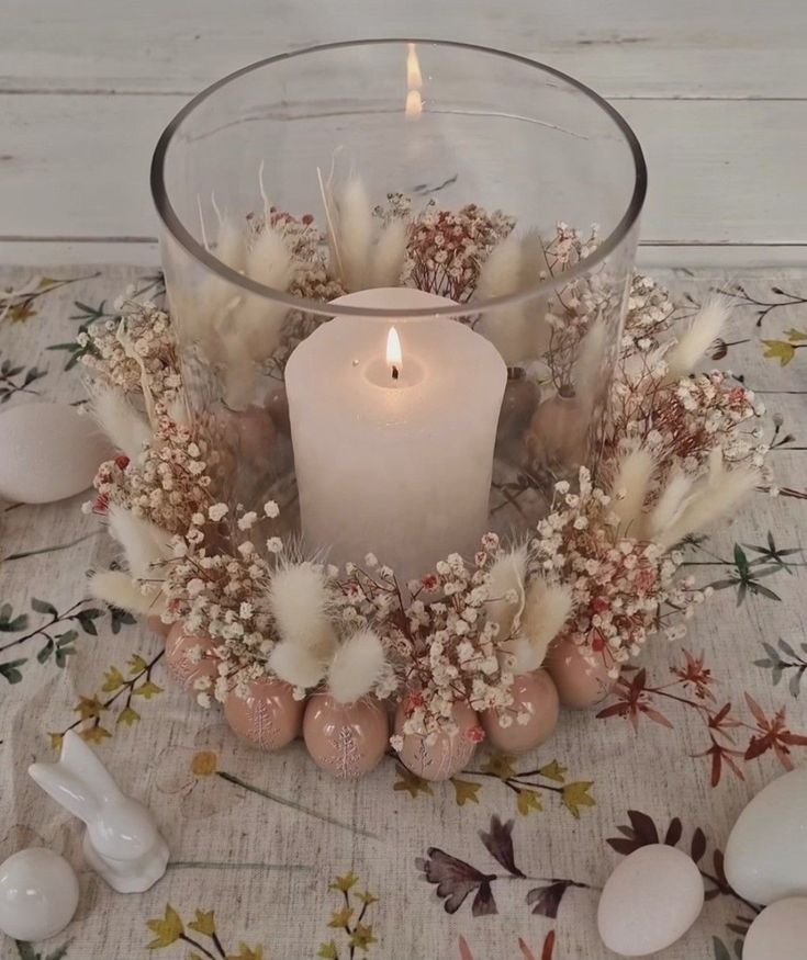 Glass candle holders decorated with sealed dried flowers and leaves, glowing from within