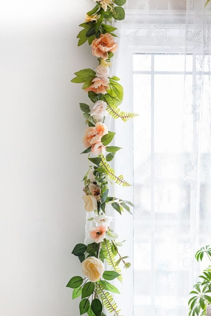 DIY paper flower garland made from colored cardstock hung across a window