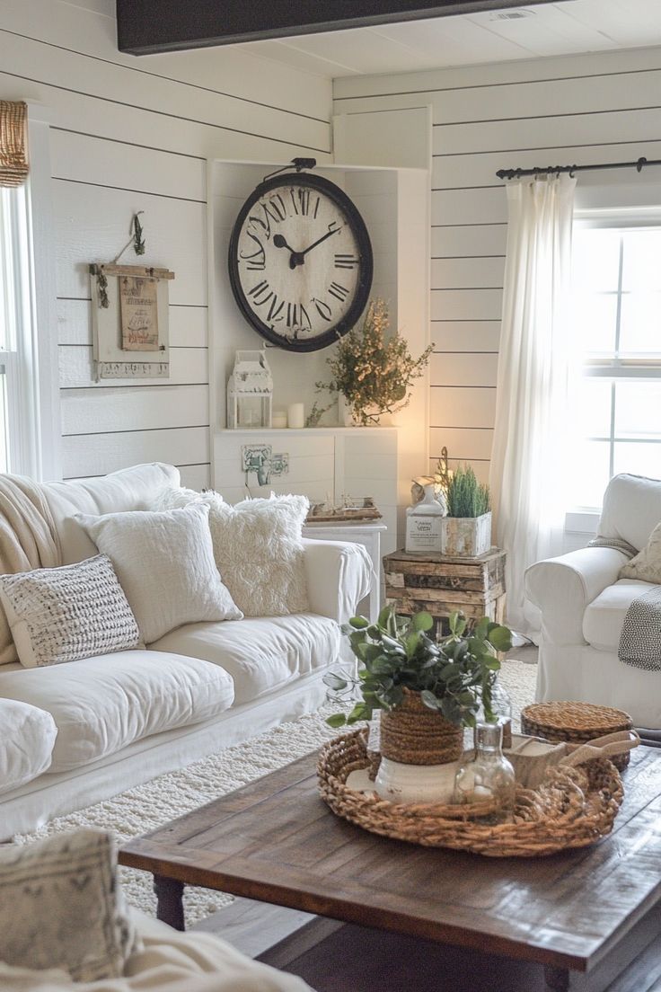 Shiplap living room with a large wood clock, wreaths, vintage white trunks and a wine barrel accent