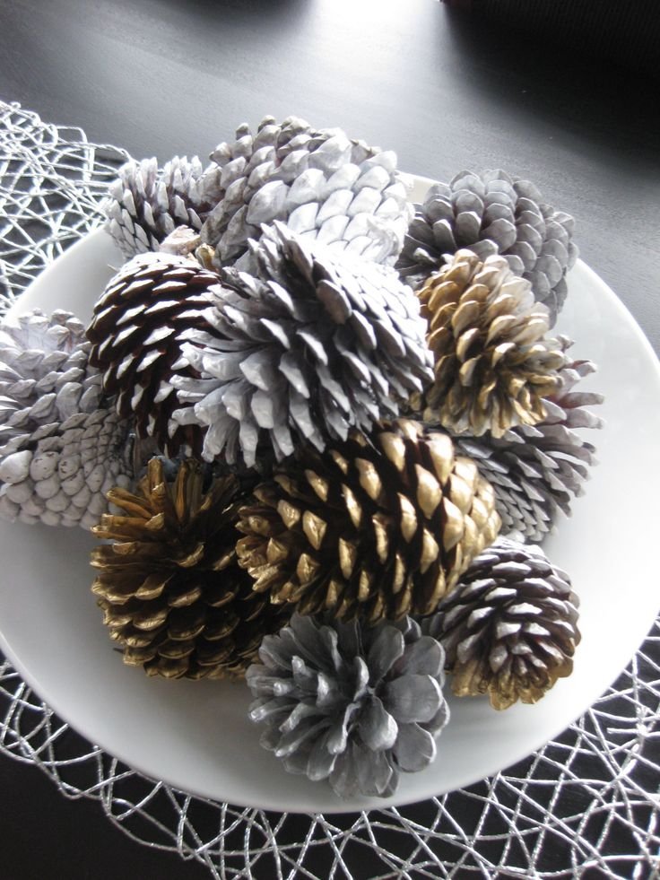 White and gold painted pinecones styled as winter decor