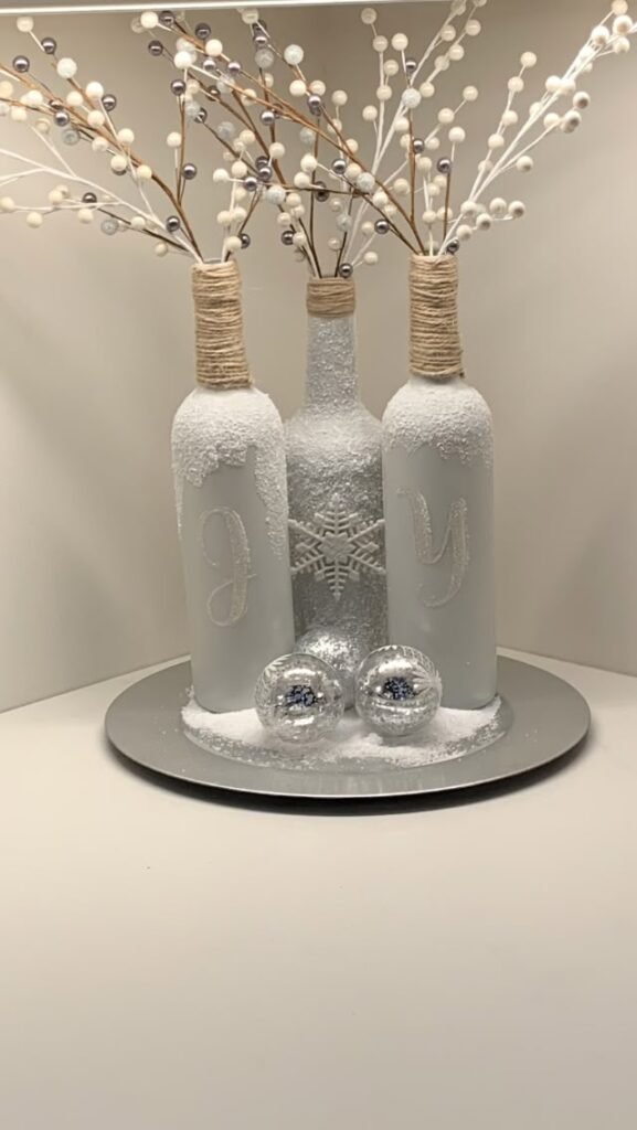 DIY snowy frosted glass bottles styled as winter decor