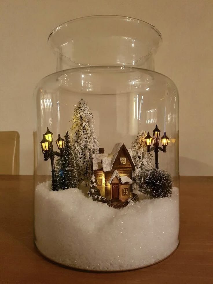 Winter terrarium with moss and faux snow in a glass container